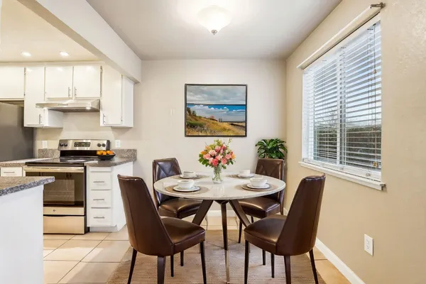 a view of a dining room with furniture and a large window