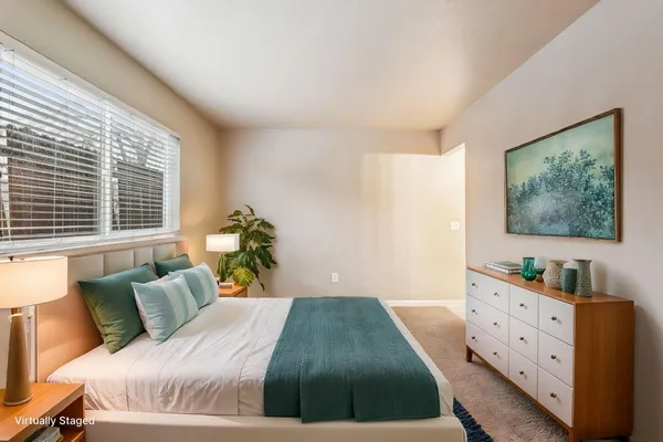 a bed room with a bed and a dresser