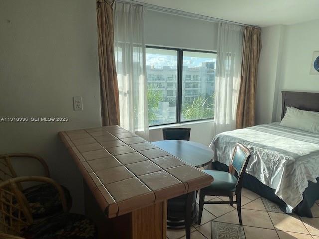 6345 Collins Avenue, Unit 614 Miami Beach, FL 33141 - Photo 8 of 12 a bedroom with a bed and a window