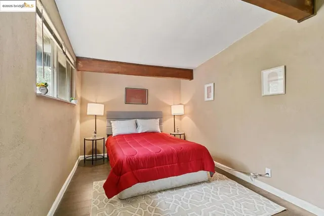 a bedroom with a bed and a potted plant