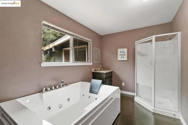 a bathroom with a bathtub and a shower