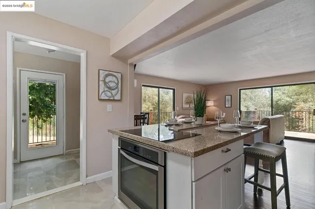a view of kitchen island a sink and living room