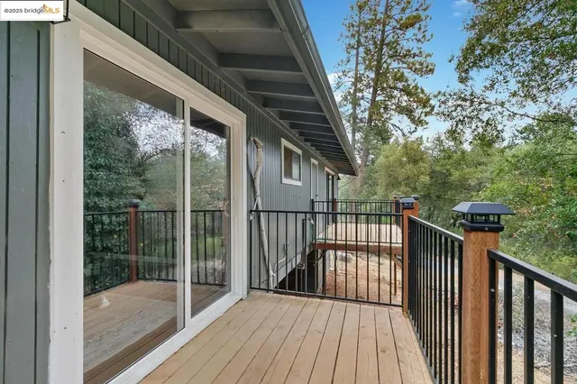 a view of balcony with wooden floor and fence