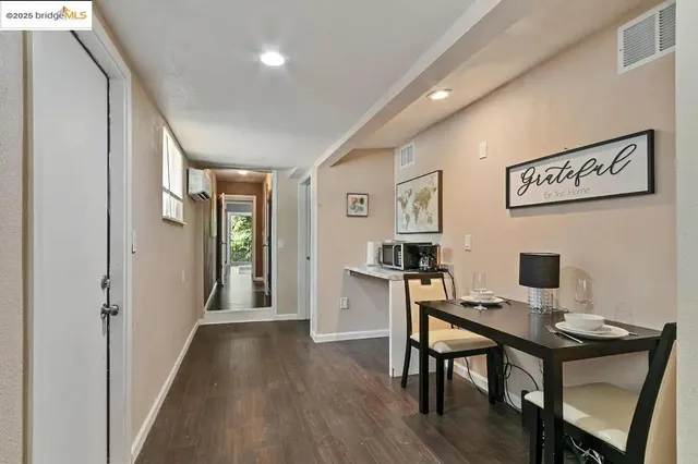 a view of a workspace with furniture and wooden floor