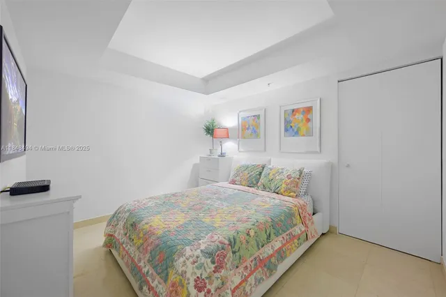 a bedroom with a bed and a bookshelf