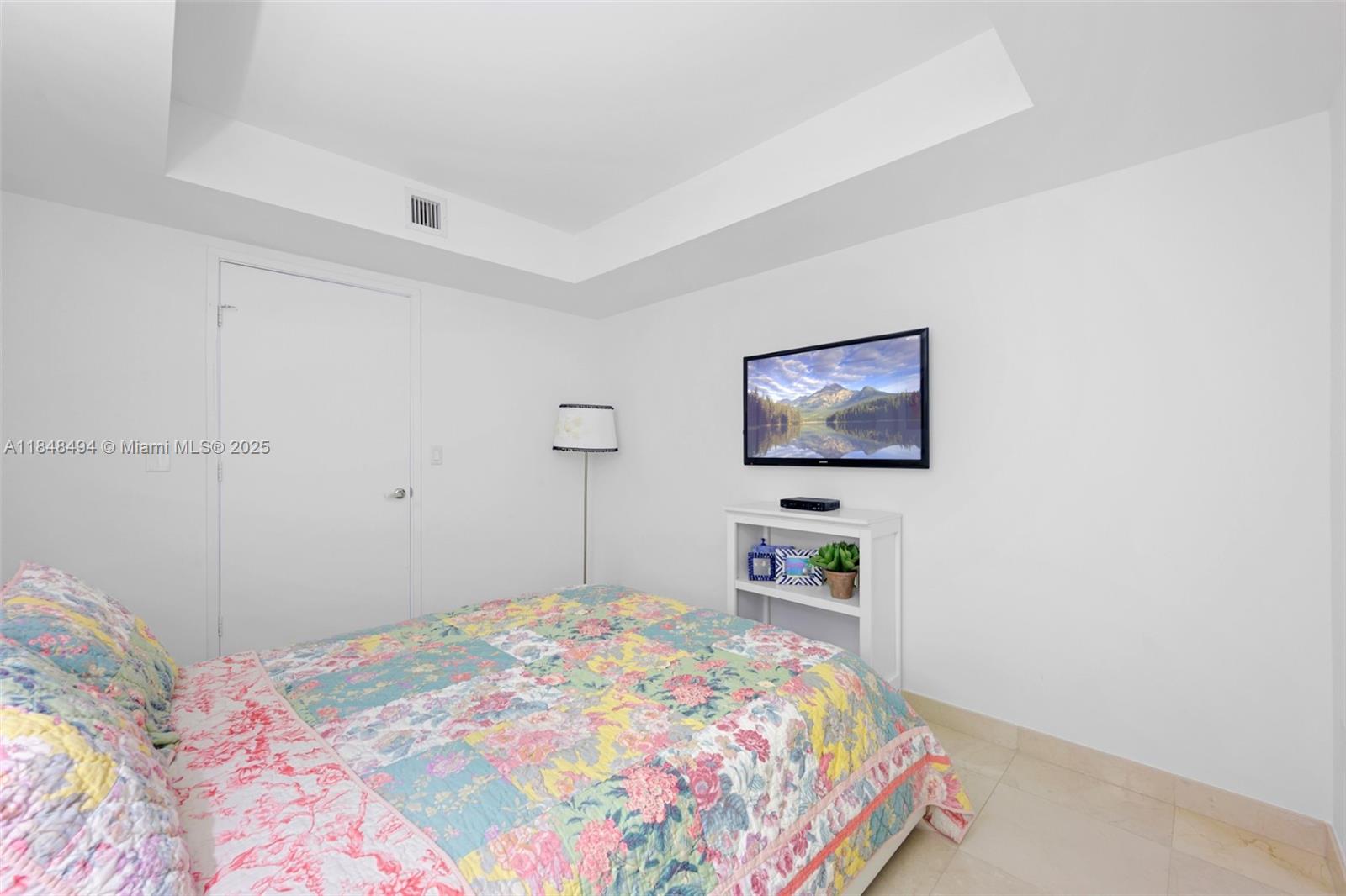 150 Sunny Isles Boulevard, Unit TH301 Sunny Isles Beach, FL 33160 - Photo 13 of 25 a bedroom with a bed and a bookshelf