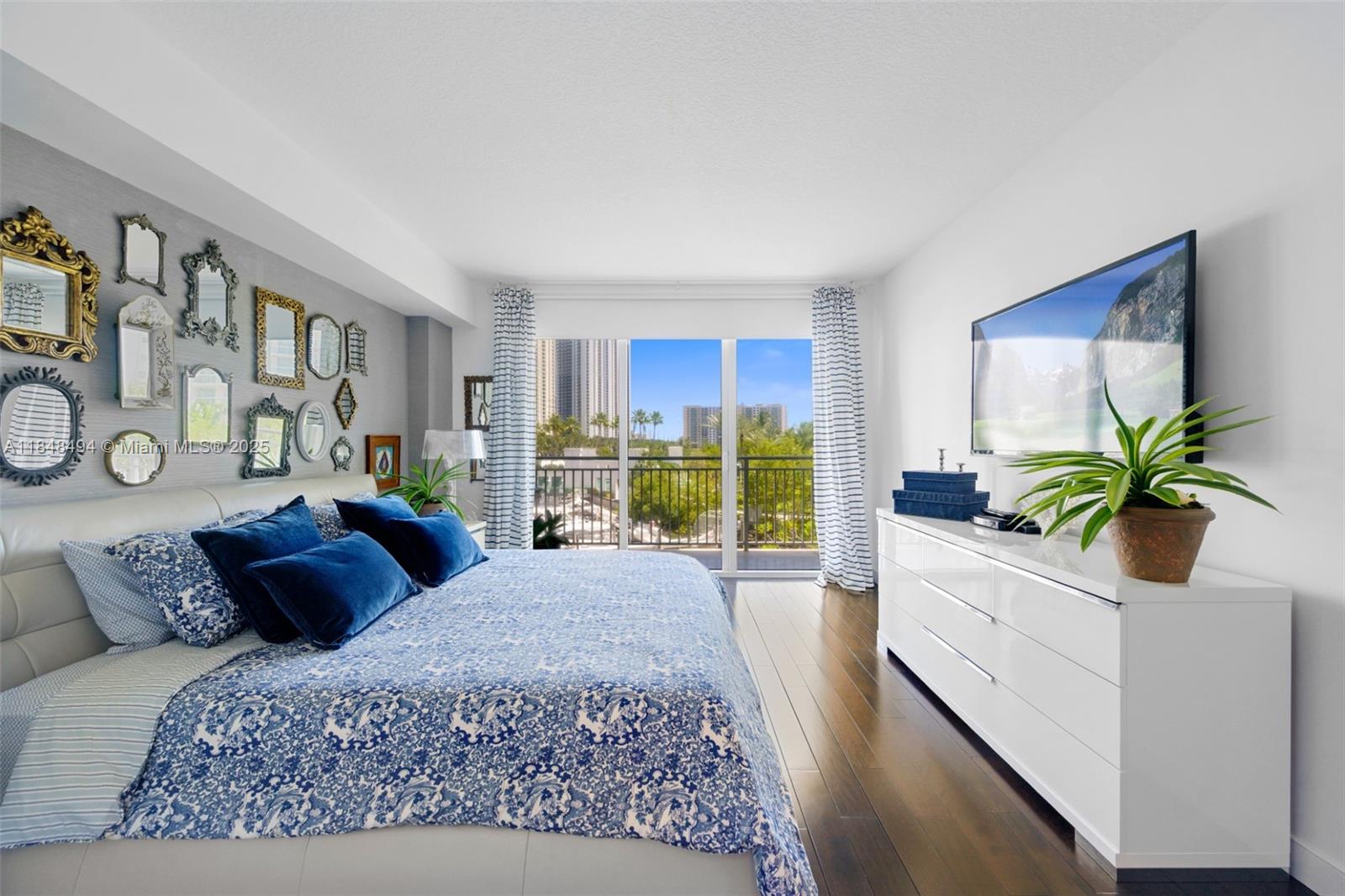 150 Sunny Isles Boulevard, Unit TH301 Sunny Isles Beach, FL 33160 - Photo 15 of 25 a bedroom with a large bed and a large window