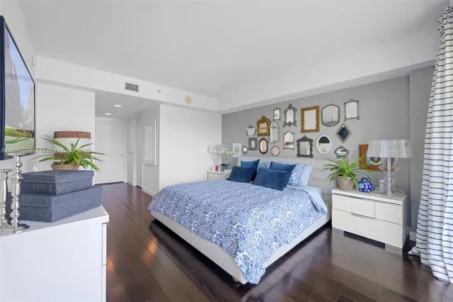 a large white bathroom with a bathtub and a sink