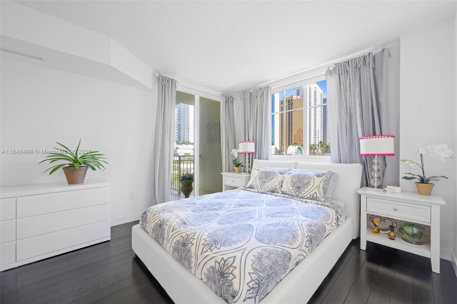 150 Sunny Isles Boulevard, Unit TH301 Sunny Isles Beach, FL 33160 - Photo 21 of 25 a bedroom with a bed and a potted plant
