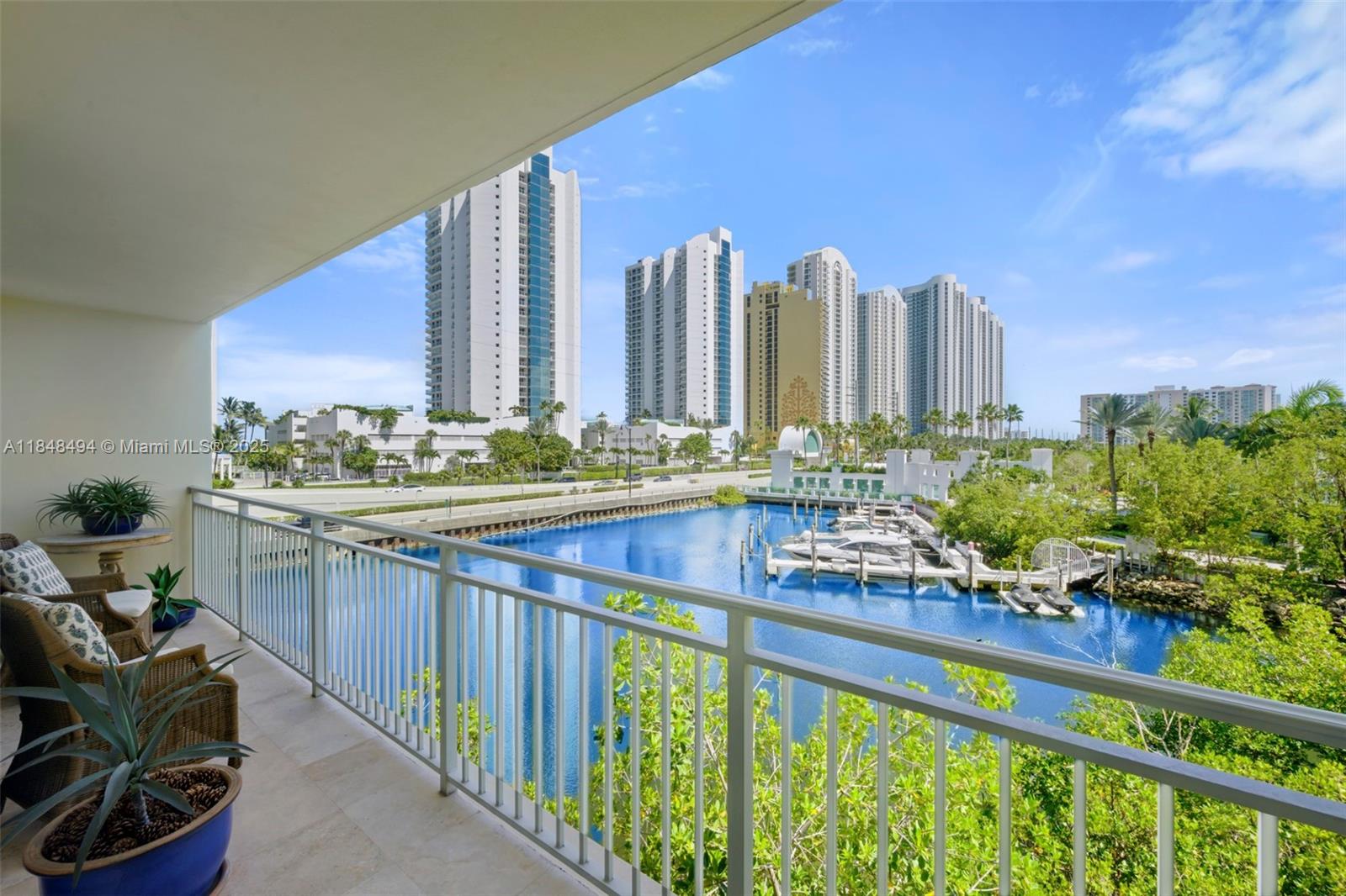 150 Sunny Isles Boulevard, Unit TH301 Sunny Isles Beach, FL 33160 - Photo 23 of 25 a view of a balcony with chairs