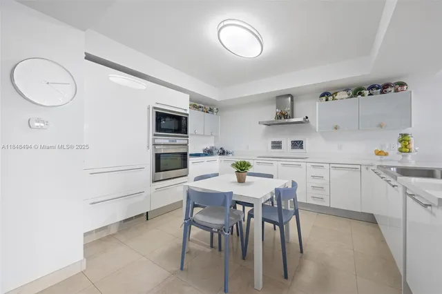 a kitchen with a table and chairs in it
