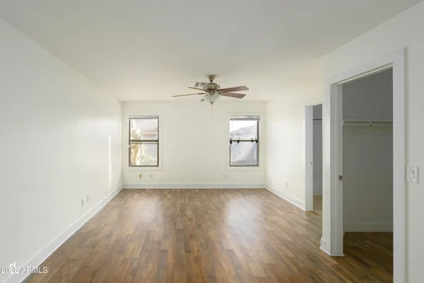 wooden floor in an empty room with a window