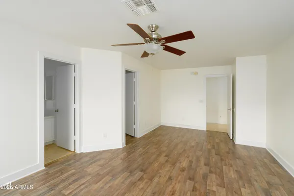 a view of empty room with wooden floor