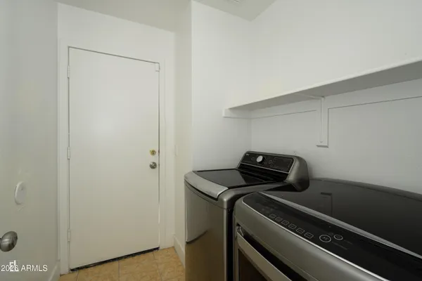 a view of storage and utility room with washer and dryer