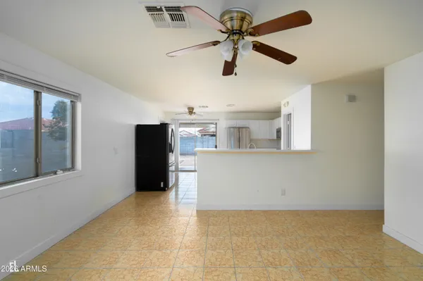 a view of a livingroom with a ceiling fan and window
