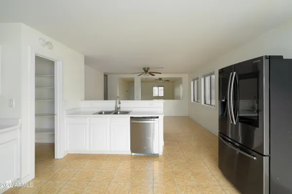 a kitchen with a refrigerator and a sink