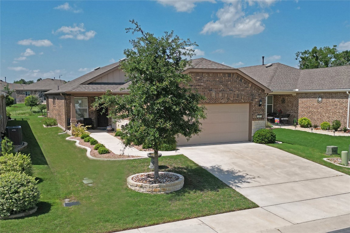 321 Brenham Pass Georgetown, TX 78633 - Photo 1 of 1 a front view of a house with yard and green space