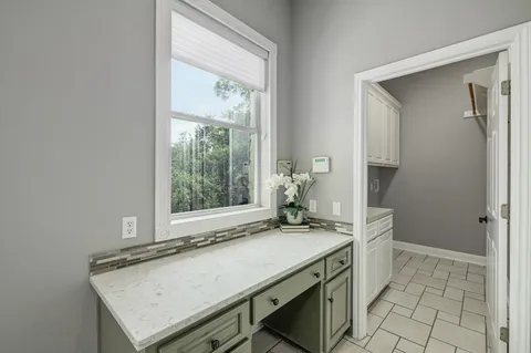 a bathroom with a granite countertop sink a toilet and a mirror