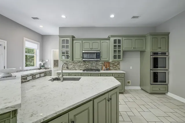 a large bedroom with a bed and a large window