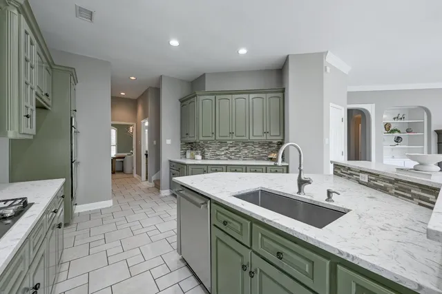 a bathroom with a granite countertop sink a large mirror and a shower