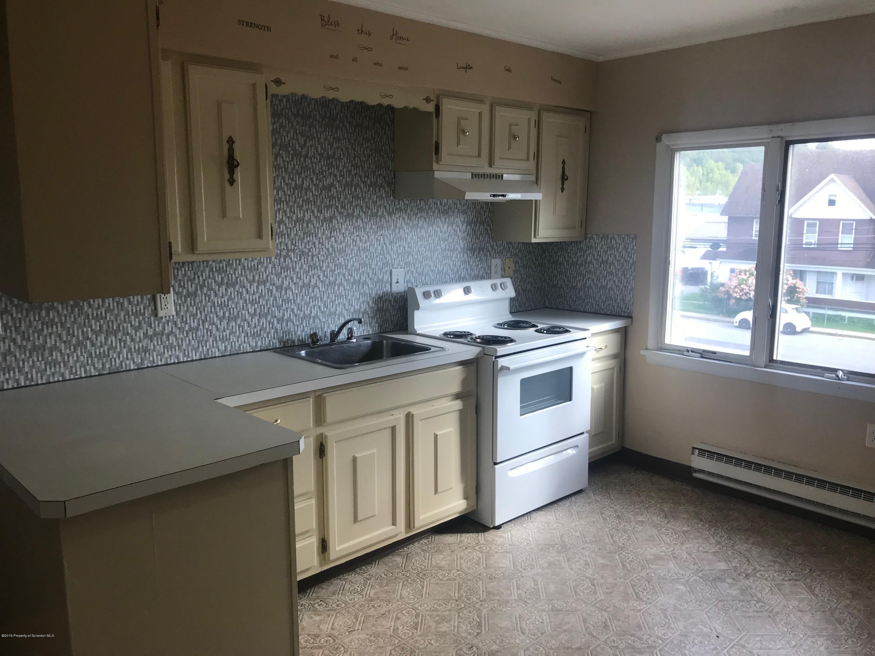 404 North Main Street, Unit 2 Simpson, PA 18407 - Photo 2 of 7 a kitchen with stainless steel appliances a sink stove and window