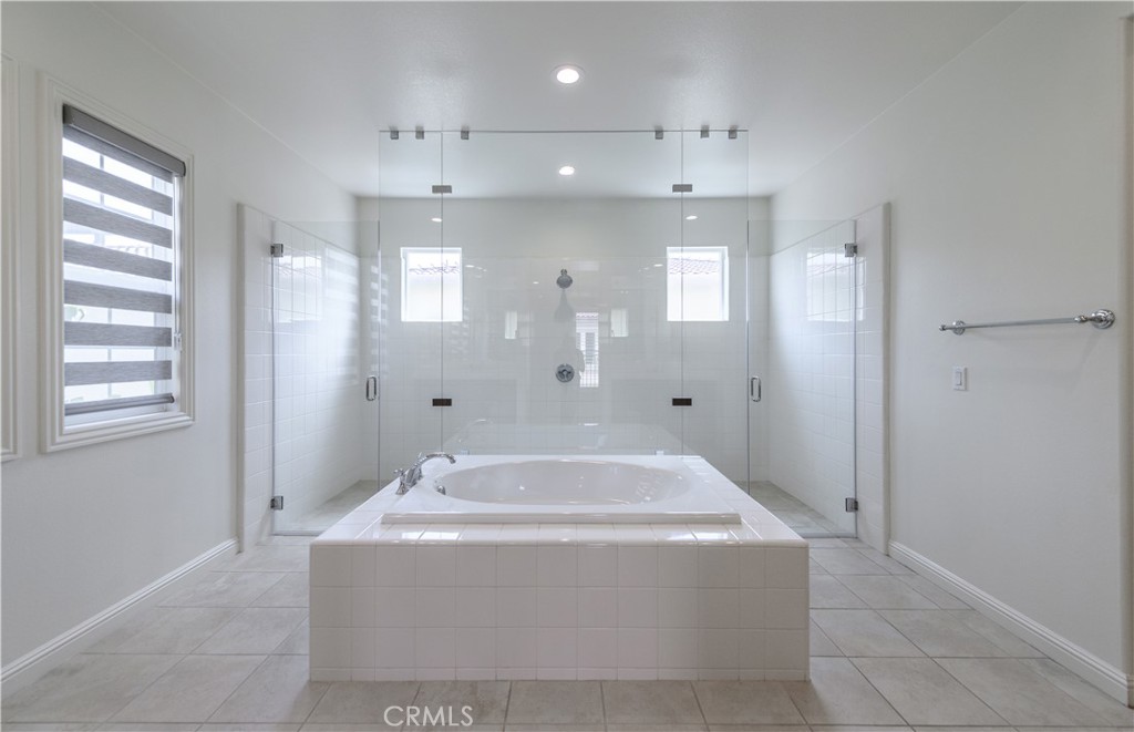a spacious bathroom with a tub shower and sink
