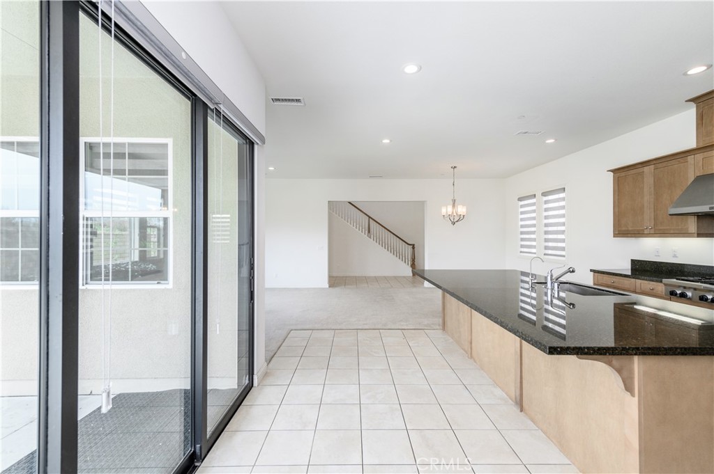 105 Bryce Run Lake Forest, CA 92630 - Photo 12 of 36 a kitchen with granite countertop a stove a sink and a refrigerator