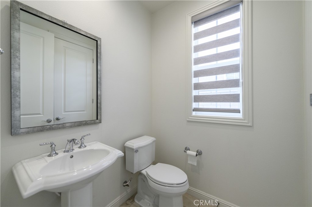105 Bryce Run Lake Forest, CA 92630 - Photo 14 of 36 a bathroom with a sink a toilet and mirror