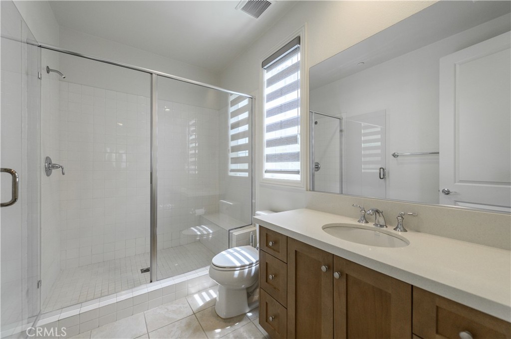 105 Bryce Run Lake Forest, CA 92630 - Photo 17 of 36 a bathroom with a shower sink vanity mirror and toilet