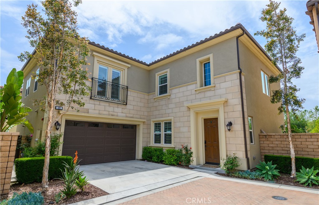 105 Bryce Run Lake Forest, CA 92630 - Photo 2 of 36 a front view of a house with a yard and garage