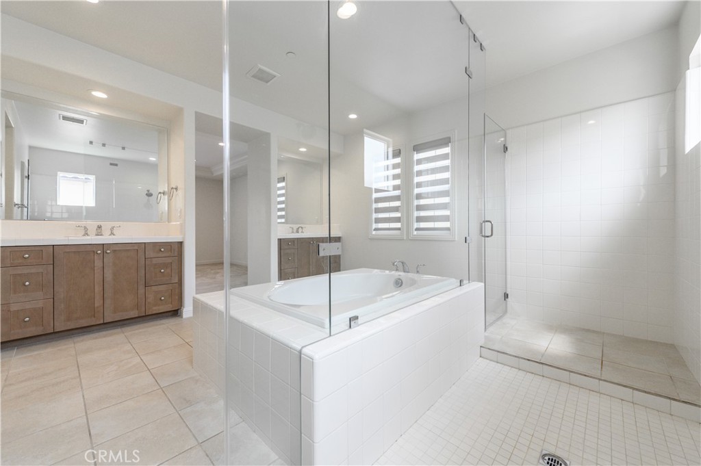 105 Bryce Run Lake Forest, CA 92630 - Photo 29 of 36 a bathroom with a tub a sink a mirror and a shower