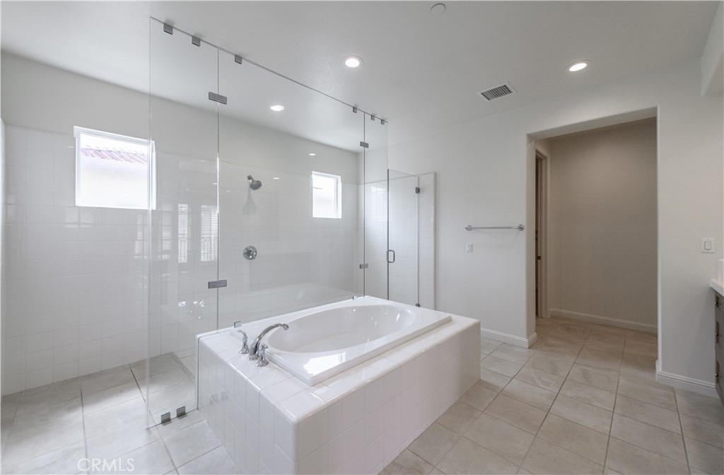 105 Bryce Run Lake Forest, CA 92630 - Photo 30 of 36 a bathroom with a granite countertop sink a shower and a mirror