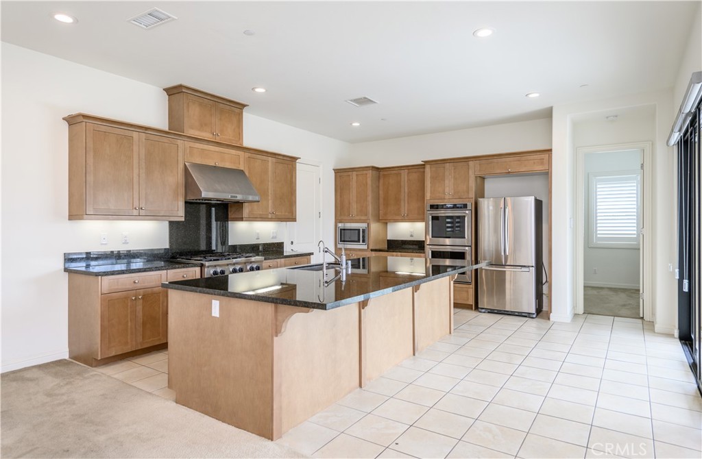 105 Bryce Run Lake Forest, CA 92630 - Photo 6 of 36 a kitchen with stainless steel appliances granite countertop a sink stove and refrigerator