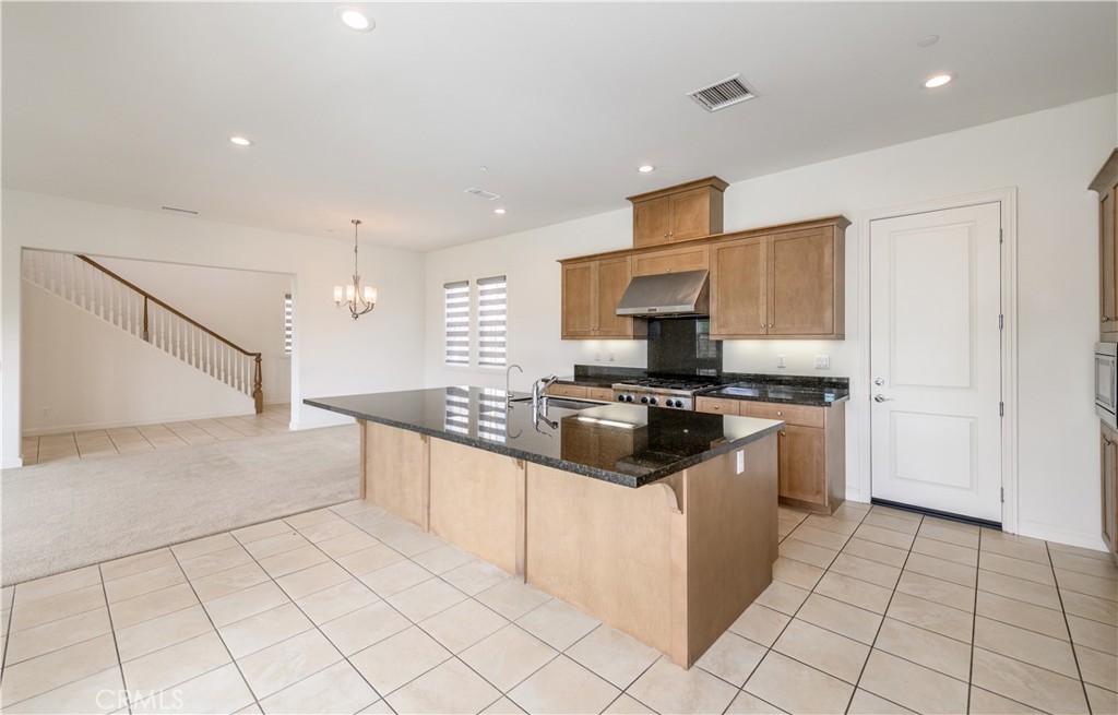 105 Bryce Run Lake Forest, CA 92630 - Photo 7 of 36 a kitchen with stainless steel appliances granite countertop a stove and a sink