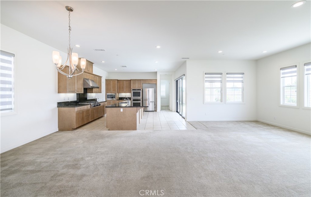 105 Bryce Run Lake Forest, CA 92630 - Photo 8 of 36 a open kitchen with cabinets and a chandelier