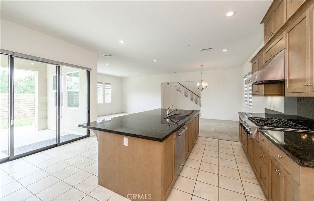 105 Bryce Run Lake Forest, CA 92630 - Photo 10 of 36 a kitchen with granite countertop a stove and a sink