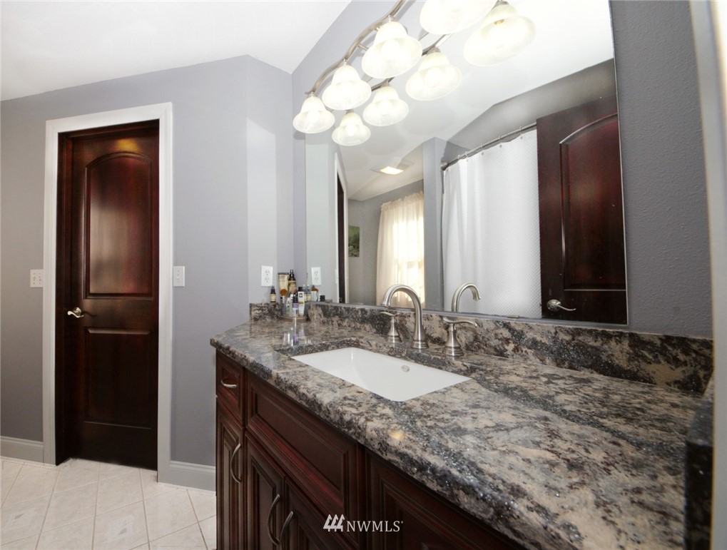 18131 Case Road Southwest Rochester, WA 98579 - Photo 13 of 16 a bathroom with a granite countertop sink and a mirror