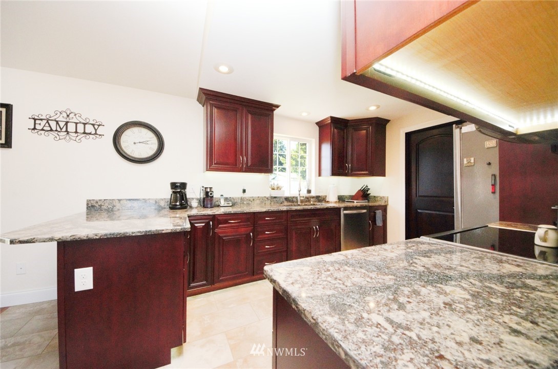 18131 Case Road Southwest Rochester, WA 98579 - Photo 4 of 16 a kitchen with granite countertop a sink a stove and cabinets