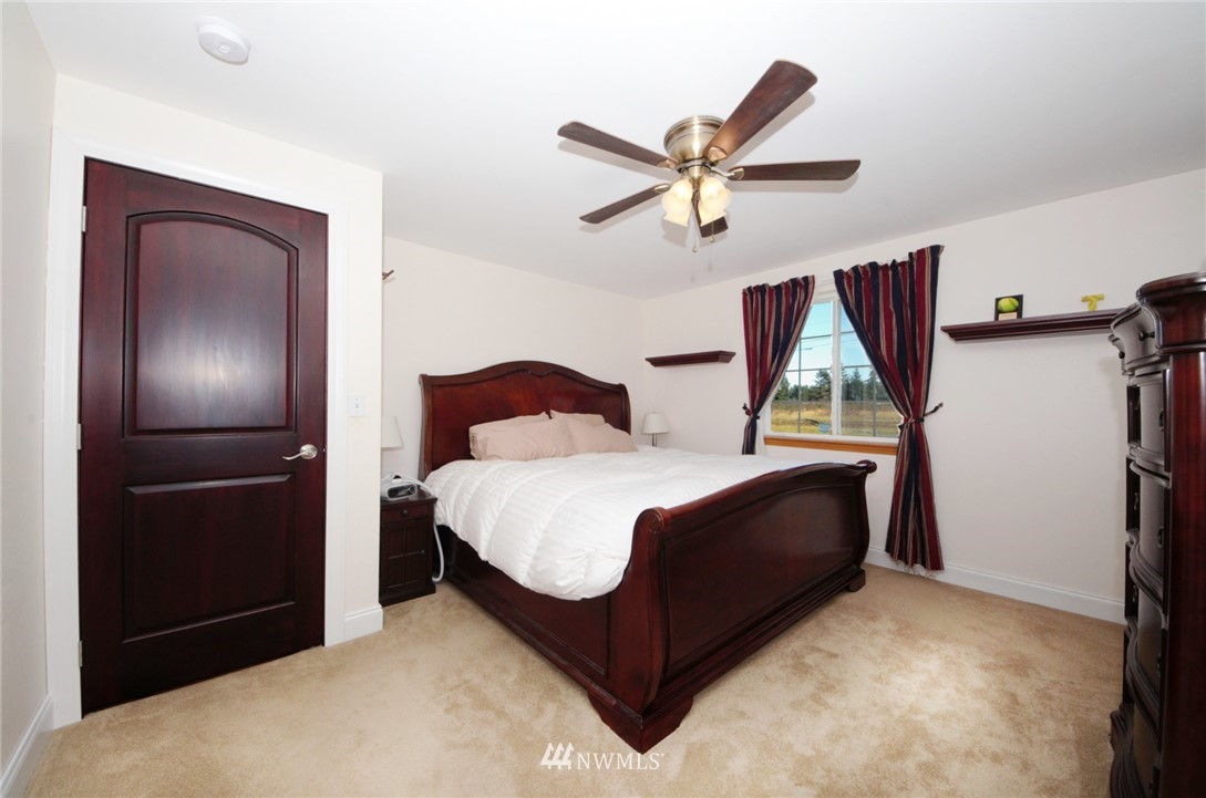 18131 Case Road Southwest Rochester, WA 98579 - Photo 10 of 16 a bedroom with a bed and a chandelier