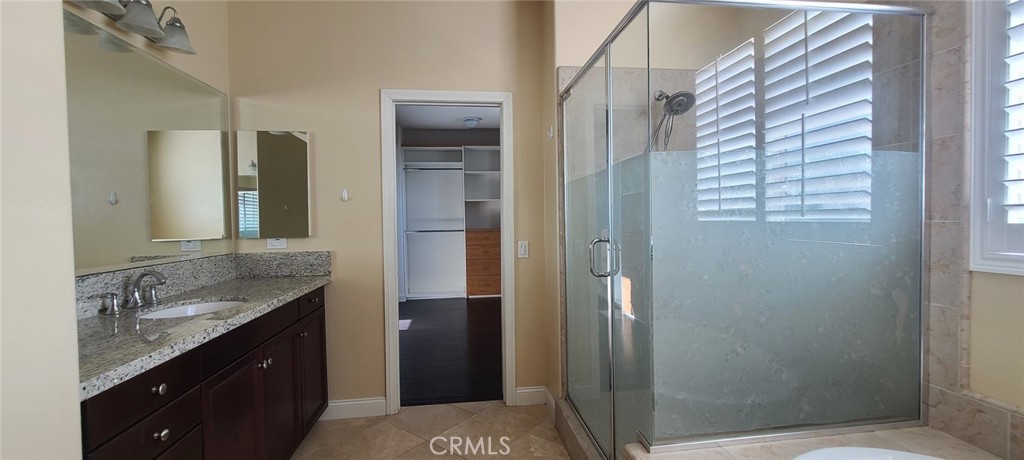 13209 Lima Drive Rancho Cucamonga, CA 91739 - Photo 14 of 25 a bathroom with a granite countertop sink toilet and shower