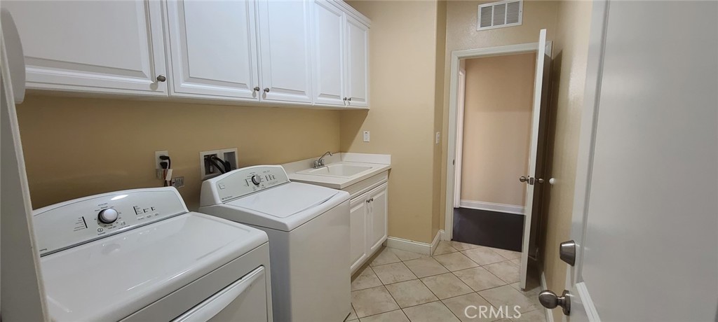 13209 Lima Drive Rancho Cucamonga, CA 91739 - Photo 24 of 25 a utility room with dryer and washer