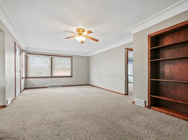284 Wilson Street Struthers, OH 44471 - Photo 7 of 16 Carpeted spare room featuring ornamental molding and ceiling fan
