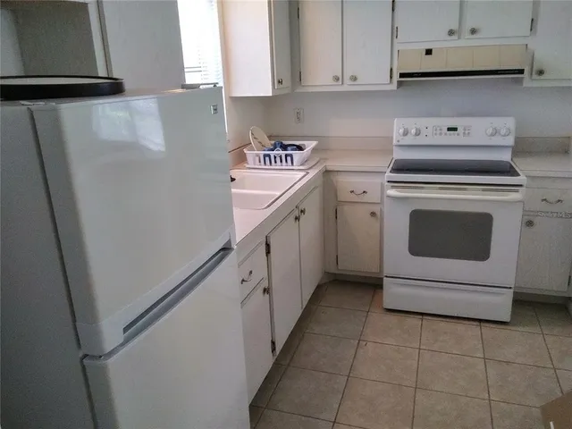 a utility room with cabinets washer and dryer