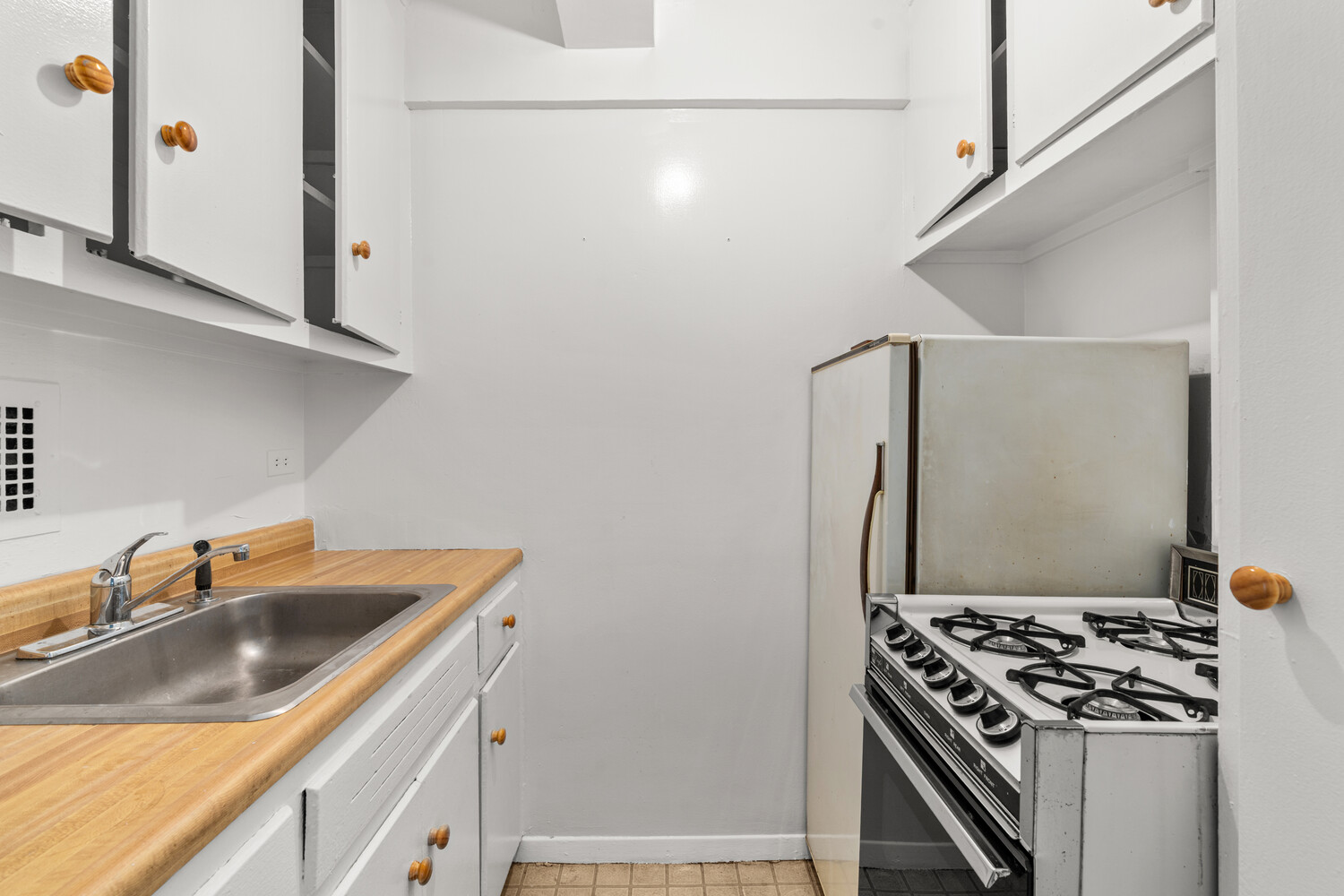 120 East 36th Street, Unit 3F Manhattan, NY 10016 - Photo 5 of 7 a kitchen with stainless steel appliances granite countertop a sink stove and refrigerator