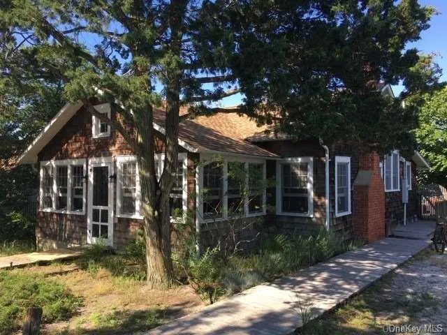 a view of house with a tree in front of it
