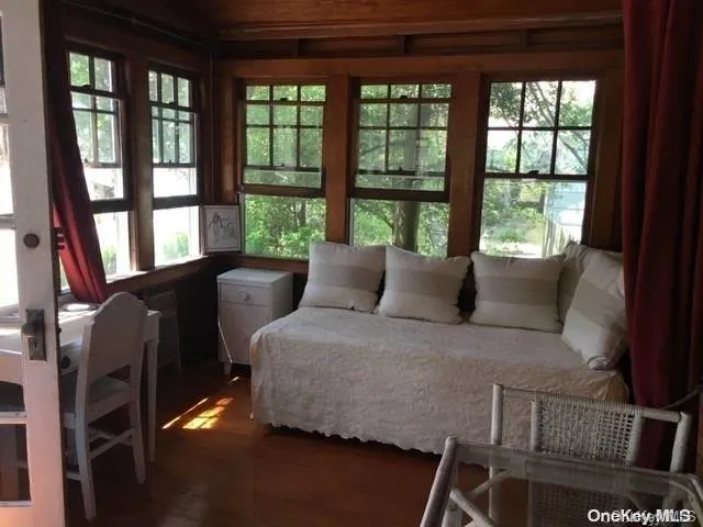 a bedroom with furniture and a large window