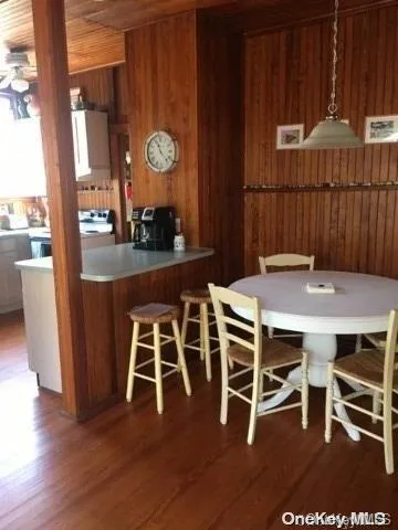 a dining room with furniture and wooden floor