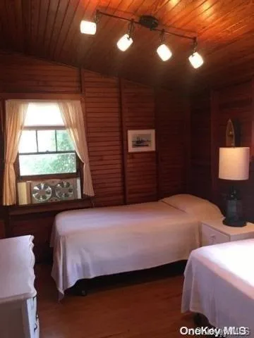 a bedroom with two beds and a large window