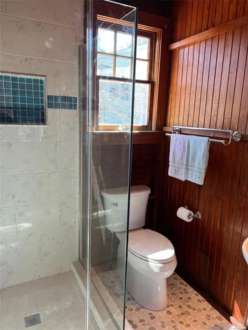 a white toilet sitting next to a bathroom sink