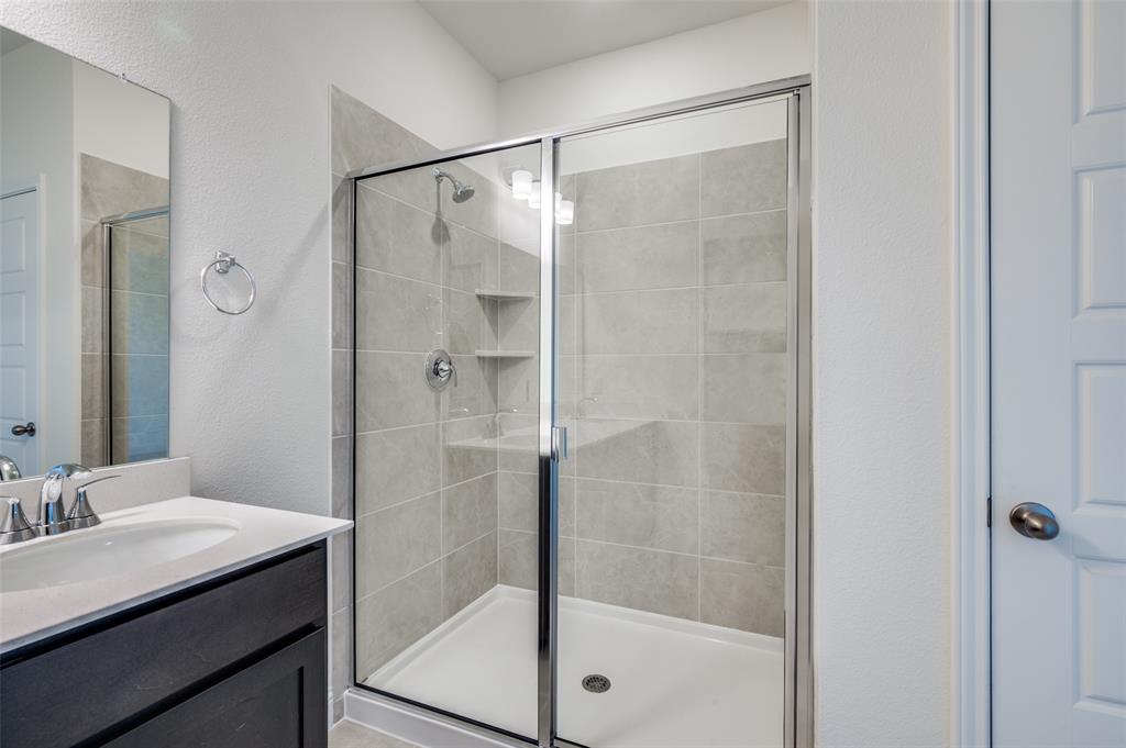 344 Fallbrook Drive Aledo, TX 76008 - Photo 10 of 28 a bathroom with a shower and a sink